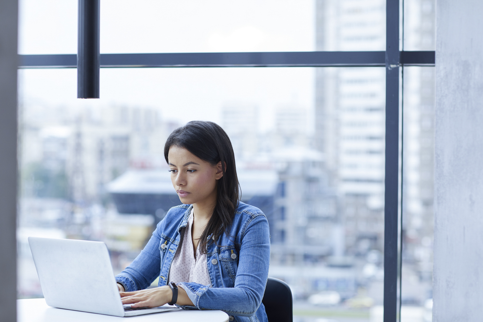 Businesswoman typing on laptop at office